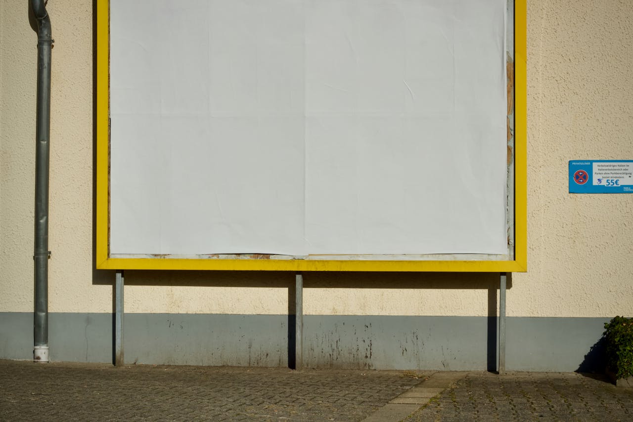 who-we-are Empty billboard on a street with yellow frame, perfect for advertisement mockup.