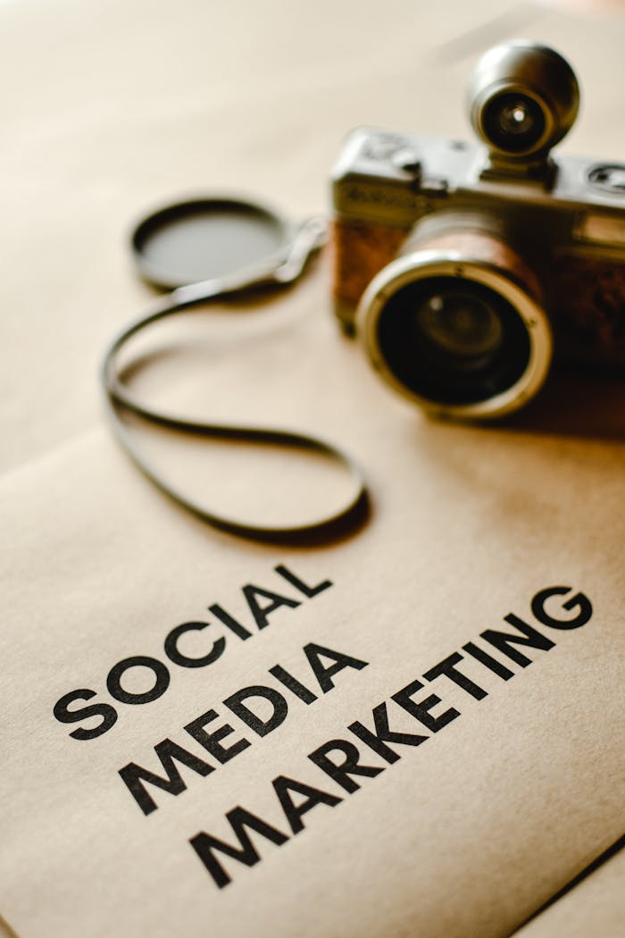 services-01 Close-up of a vintage camera on brown paper labeled with 'Social Media Marketing'.